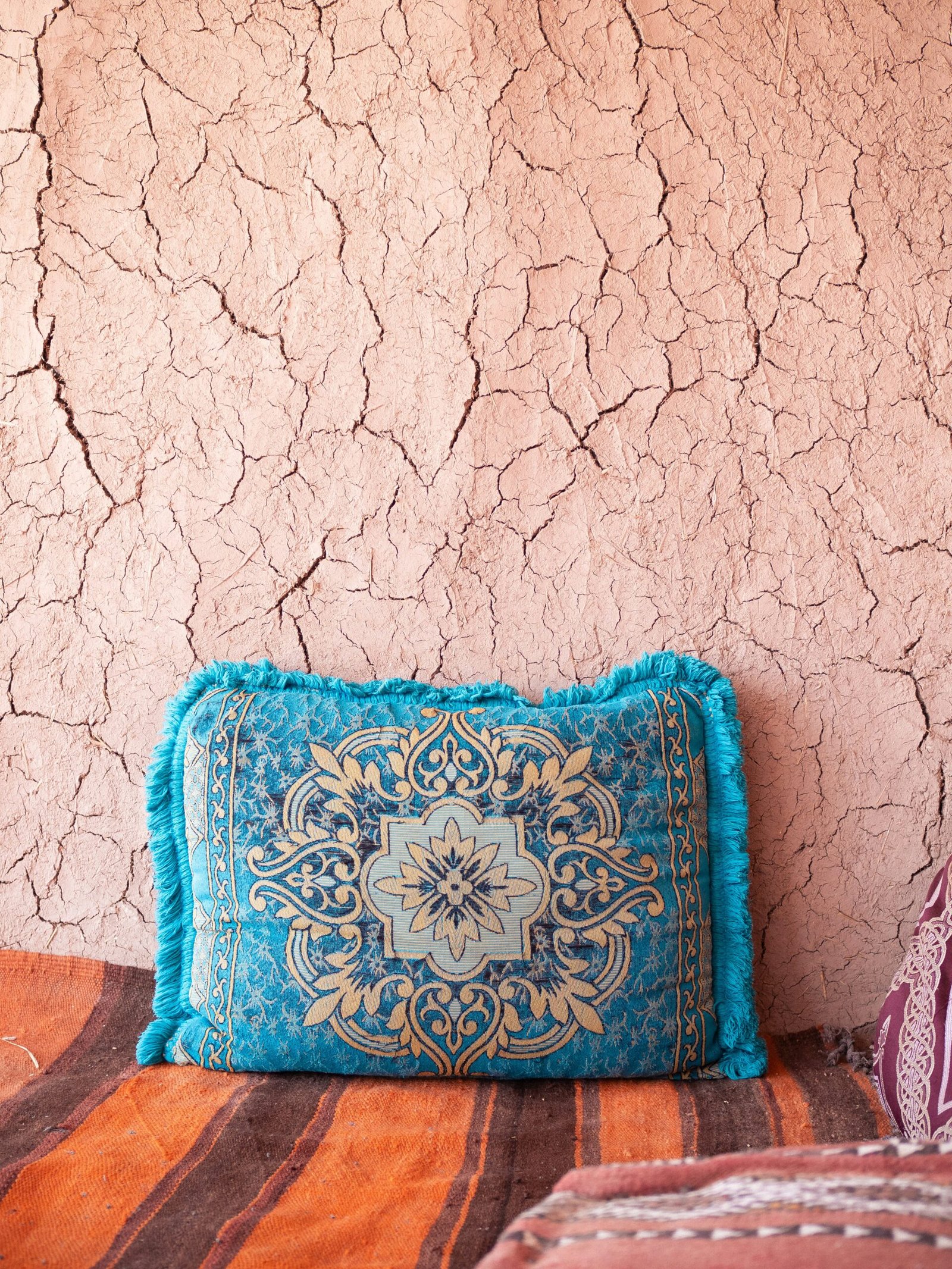 a blue pillow sitting on top of a bed